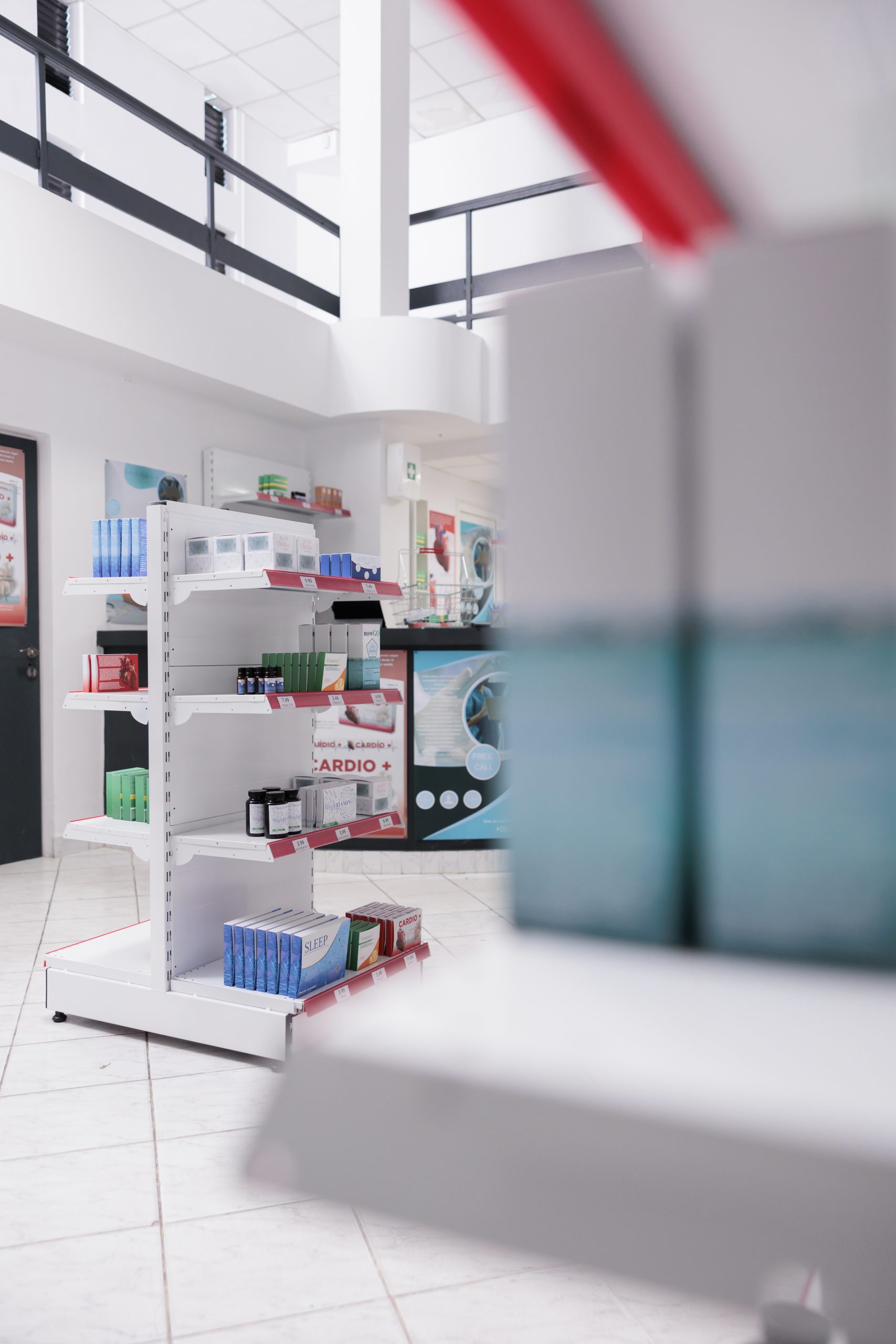 Drugstore shelves filled with pills and pharmaceutical products to sell prescription medicine or treatment to sick clients. Empty pharmacy with medication, supplements and drugs bottles.