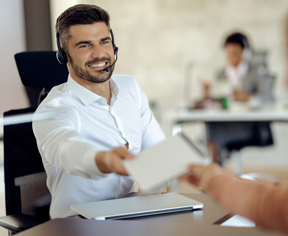 happy-businessman-cooperating-with-his-colleague-while-working-office (1) (1)